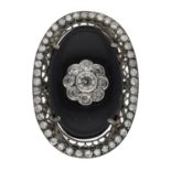 Fancy large oval white metal diamond and black onyx cocktail ring, with a round brilliant-cut