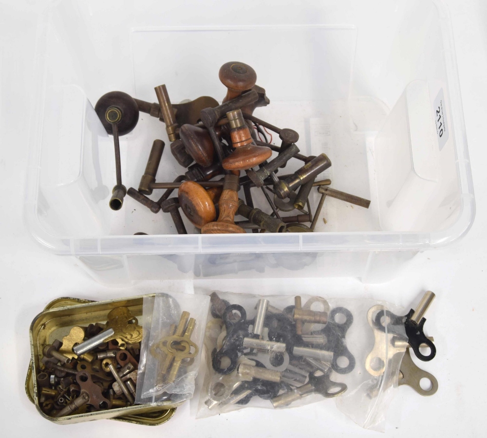 Ten various crank clock keys with turned wooden handles; also various other clock keys