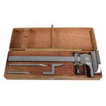 Good quality stainless steel measuring gauge, within a fitted wooden box with attachments, 14.75"