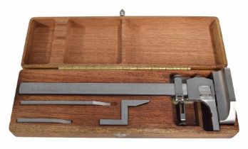 Good quality stainless steel measuring gauge, within a fitted wooden box with attachments, 14.75"