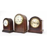 French mahogany two train mantel clock striking on a gong, within a rounded arched inlaid case, 13.