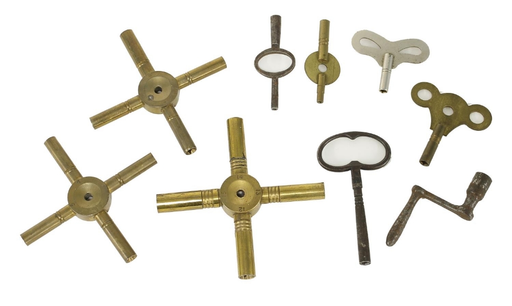 Three brass spider clock keys; together with a small quantity of other clock keys