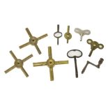 Three brass spider clock keys; together with a small quantity of other clock keys