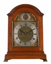 Small oak double fusee bracket clock, the 7" brass arched dial with silvered chapter ring