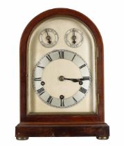 Mahogany three train mantel clock, the 6.5" silvered rounded arched dial plate with subsidiary