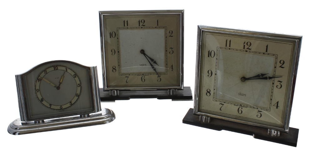 Two similar Smiths eight day mantel clocks within chrome cases and upon Bakelite stands, 6.25" high;