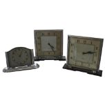 Two similar Smiths eight day mantel clocks within chrome cases and upon Bakelite stands, 6.25" high;