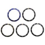 Rolex - Four black bezel inserts; together with a blue bezel insert (5)