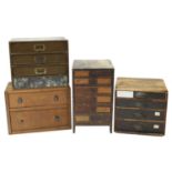 Four small storage chests containing a quantity of assorted watch glasses