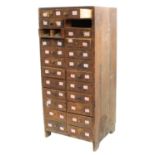 Twelve drawer wooden chest containing a quantity of assorted watch glasses of various sizes, 27.