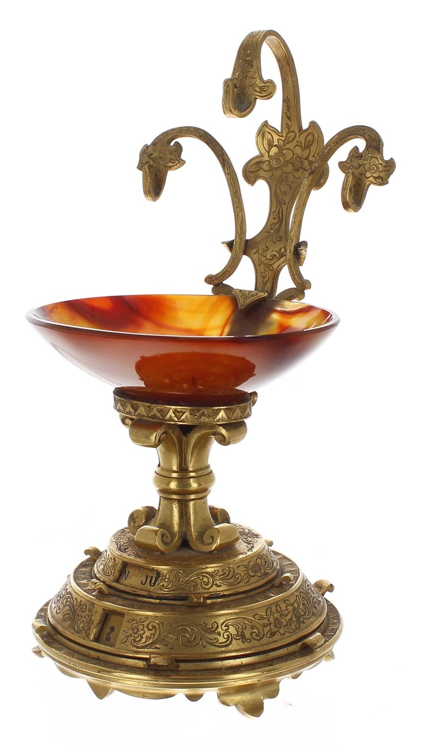 Good Aesthetic ormolu pocket watch stand with calendar, with three supports over a carnelian oval