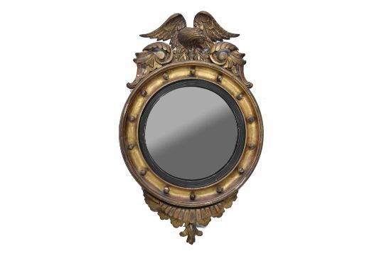 19th century convex giltwood and gesso convex wall mirror, surmounted by an eagle over a circular