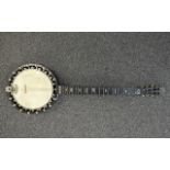 CLIFFORD ESSEX CO; a cased six string banjo with mother of pearl inlaid detail to the rosewood neck,