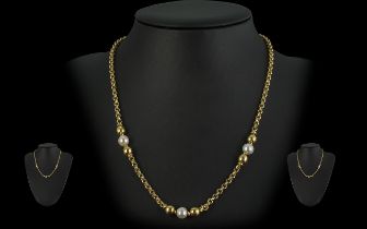18ct Gold Necklace set with pearls and gold baubles, with a lobster claw fitting. Marked 18ct. In