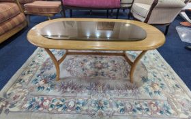 Ercol Blonde Coffee Table, oval shape, turned supports, measures 19'' height x 45'' length x 23''