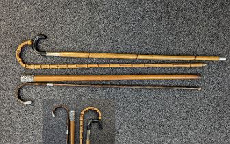 Four Vintage Walking Sticks, comprising a bamboo stick, and three silver topped canes.