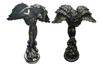 Modern Bronze Figure of a nude Angel with spread wings, mounted on a round wooden base. Measures