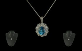 Sterling Silver Pendant, set with a blue stone surrounded by crystals, suspended on a silver chain.