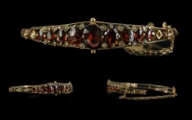 Antique 9ct Gold Bangle - Set With garnets and Seed Pearls. Typical Edwardian Design. Safety