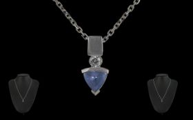 14ct White Gold Tanzanite Pendant, suspended on a chain marked 585 Italy. Drop pendant in arrow