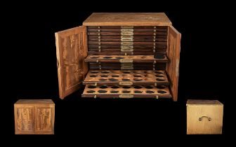 Wooden Coin Cabinet made by Swann, two opening doors to reveal 16 coin drawers, with key to lock