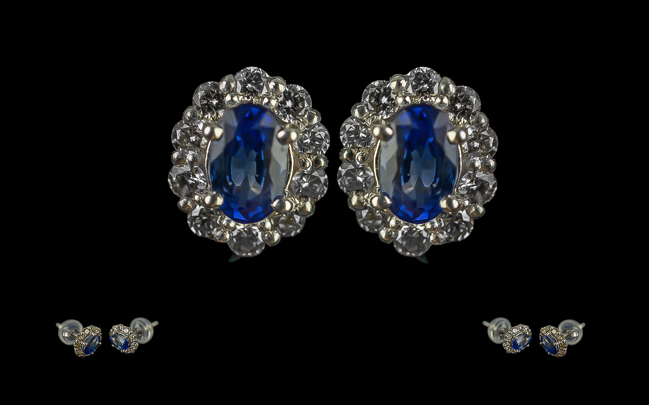 Pair of 18ct White Gold Sapphire and Diamond Scalloped Stud Earrings, boxed. Oval sapphires 0.60ct.