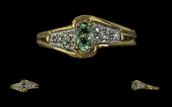 18ct Gold Ladies Dress Ring, central pale green stone on twist style diamond shoulders. Ring size