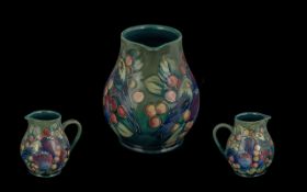 Moorcroft Tubelined Jug ' Birds and Berries ' Design on Green / Blue Ground. Height 5.75 Inches.