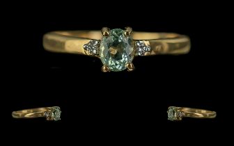 18ct Gold Ladies Dress Ring, central pale green stone with a single diamond on each shoulder. Ring