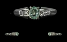 18ct White Gold Ladies Contemporary Dress Ring, central pale green stone with diamond shoulders.