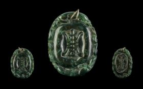 Jadeite Amulet Pendant, dark spinach colour, measures 2'' x 1.5''.