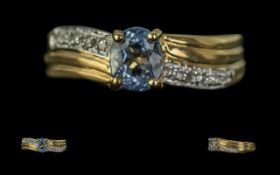 18ct Gold Ladies Dress Ring, twist style diamond set shoulders with a central blue stone. Ring