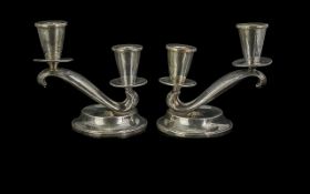 Pair of Silver Candlesticks, one low and one higher level, on a circular base, Measure 5'' high.