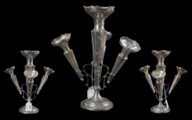 A Silver Eperne, hallmarked for Chester of typical form with three trumpet vases. Loaded base.