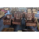 Three Tetrad Leather Armchairs, dark brown, one buttoned back, soft brown leather, together with a