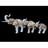 Set of Three Royal Dux Elephants, largest measures 10'' tall x 15'' wide.