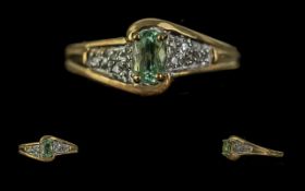 18ct Gold Ladies Dress Ring, central pale green stone on twist style diamond shoulders. Ring size