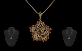 Ladies 14ct Gold Beverley Hills Fancy Open worked Pendant, set with orange garnets. Attached to a