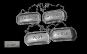 Queen Elizabeth II Set of Four Sterling Silver Spirit Labels. Comprises Brandy, Whisky, Sherry,
