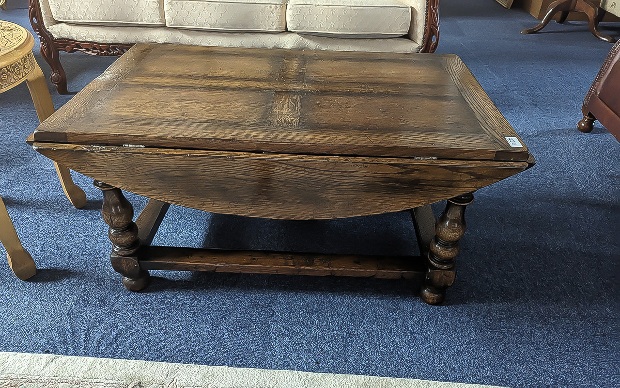 Oak Drop Leaf Coffee Table by Titchmarsh & Goodwin, of rectangular form, with turned legs and
