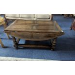 Oak Drop Leaf Coffee Table by Titchmarsh & Goodwin, of rectangular form, with turned legs and