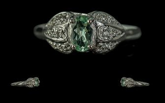 18ct White Gold Ladies Contemporary Dress Ring, central pale green stone set with diamond shoulders.