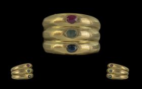 18ct Gold Trilogy Banded Gem Set Ring. Set with Blue Sapphire Emerald and Ruby all of Good Colour.