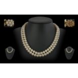 A Fine Quality Double Strand Cultured Pearl Necklace with 9ct Gold Clasp, Set with Pearls. Marked