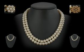 A Fine Quality Double Strand Cultured Pearl Necklace with 9ct Gold Clasp, Set with Pearls. Marked