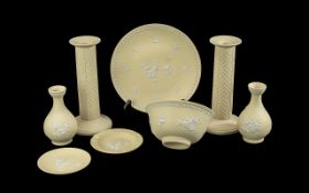 Collection of Yellow Wedgwood Jasperware, comprising two 8'' candlesticks, two bud vases 5'' high, a
