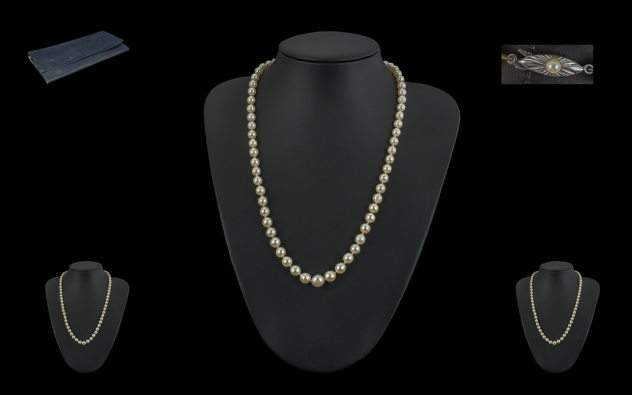 Single Strand Pearl Necklace, with 18ct gold fastener, set with a small pearl. Necklace knotted