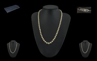 Single Strand Pearl Necklace, with 18ct gold fastener, set with a small pearl. Necklace knotted