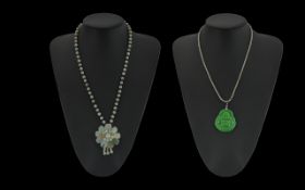 Two Necklets, comprising a jade and silver necklace and a Buddha in green.