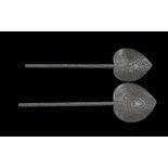 A Pair of Persian Silver Spoons profusely decorated with floral detail throughout. Approximately